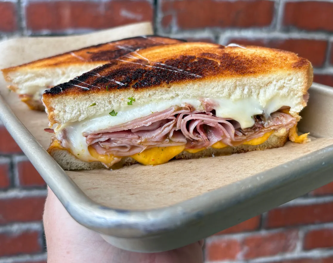 Grilled ham and cheese sandwich on a tray